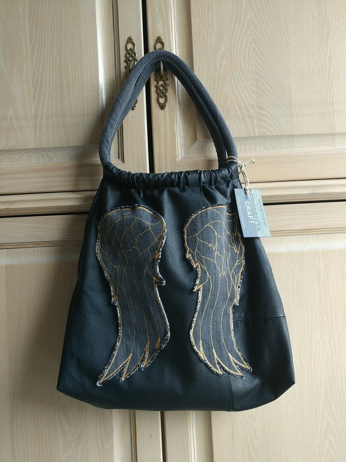 Black genuine leather tote bag with gray wings